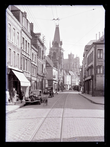 Rue commerçante animée d'Amiens (Somme) avec vue au loin de la cathédrale..
