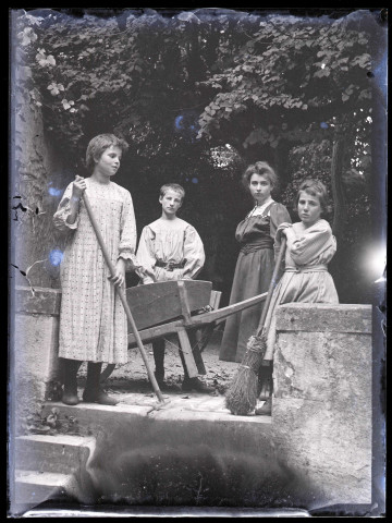 Femme et enfants au travail dans un jardin.
