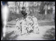Melle Bonjean avec un groupe d'enfants dans un jardin.
