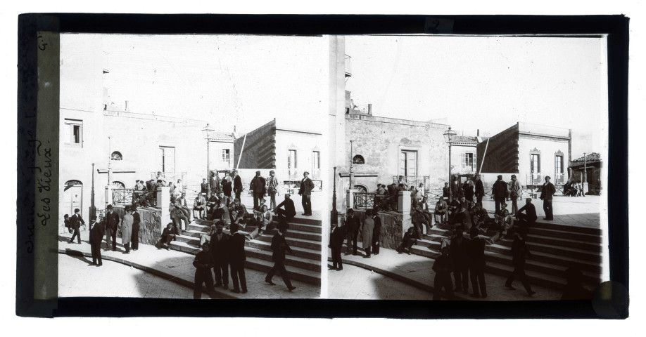 Siciliens discutant assis sur les marches d'une place de Girgenti en Sicile (Italie).