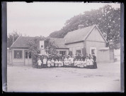 Religieuses du Sacré-Cœur et enfants de chœur devant une habitation.