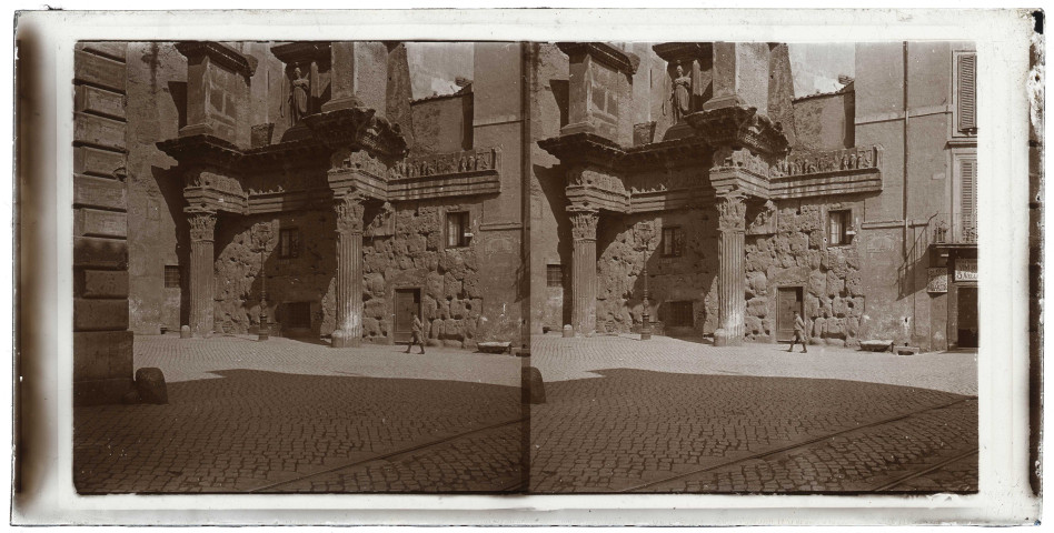 Monument à colonnes et à statue d'ange sur une place de ville italienne.