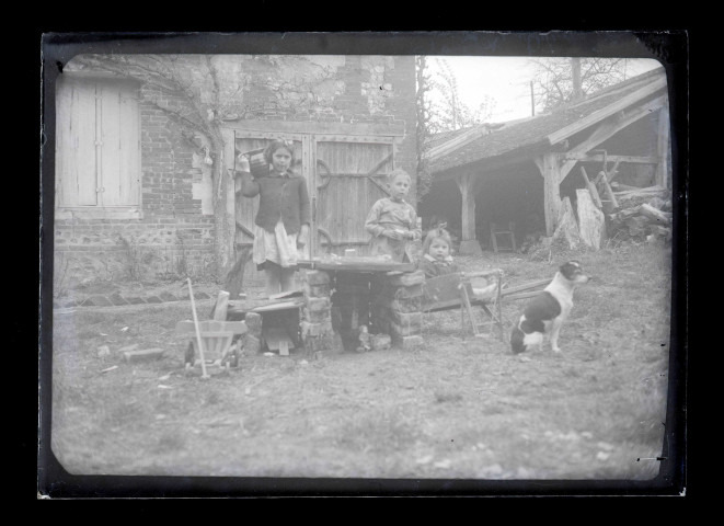 Enfants et chien autour d'un puits.
