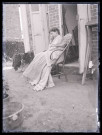 Femme au repos dans une chaise en bois.