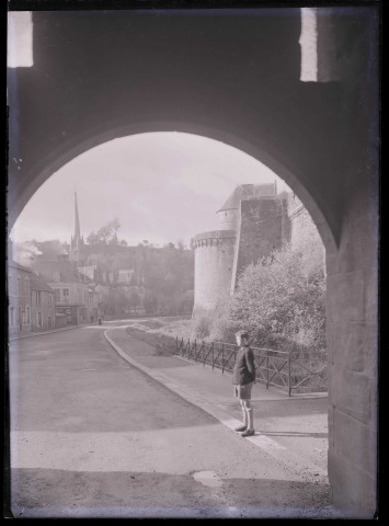 Promenade au pied des remparts de Fougères (Ille-et-Vilaine), avec au loin le clocher de l'église Saint-Sulpice.