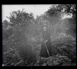 Vieille femme dans un potager.