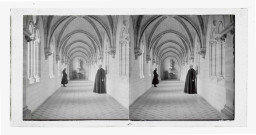 Le chanoine Le Fournier habit sacerdotal et moine dans la galerie d'un cloître.