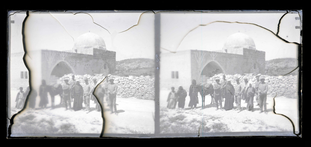 Expéditionnaires, bédouins et leur monture devant un mausolée.